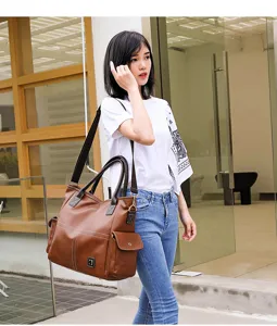 Details of large capacity brown leather shoulder bag, commuter tote showing multi-pocket design.