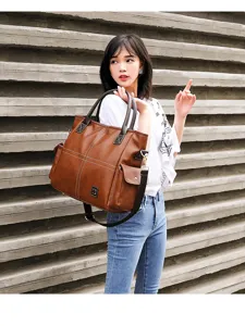 Brown PU leather tote bag for women, large capacity shoulder commuting handbag with strap.