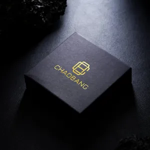 Close-up detail of luxury black jewelry gift box with gold foil logo and premium texture.