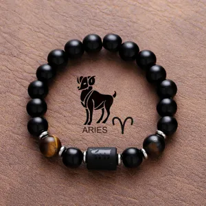Close-up shot of the black obsidian and tiger eye bead bracelet featuring Aries zodiac design.