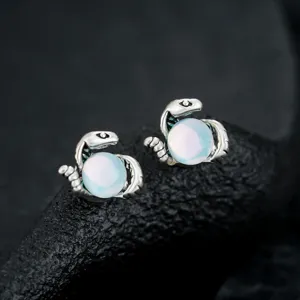 Exquisite snake-shaped magnetic ear clips with glowing blue beads, detailed jewelry.
