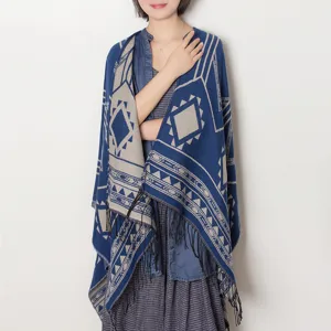 Detailed view of the blue geometric patterned winter tassel shawl cape, showcasing cozy knit style.