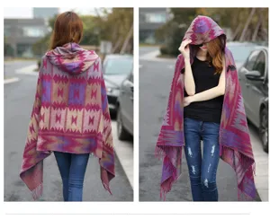 Detail view of women's ethnic geometric hooded cape shawl with tassels and button.