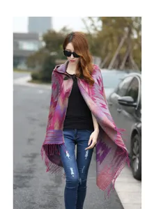 Ethnic style hooded tassel shawl detail shot, showing the exquisite patterned fabric and button.