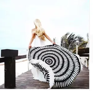 Gedetailleerd scène van een zwart-witte geometrische ronde stranddoek met franjes.