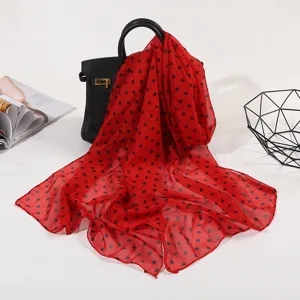 Red polka dot silk scarf detail view, lightweight breathable fabric drape design style showcase