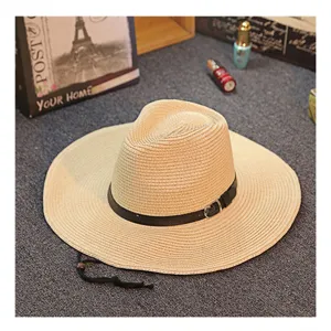 Men's straw sun hat with wide brim, black leather belt decor, and chin strap for summer beach.