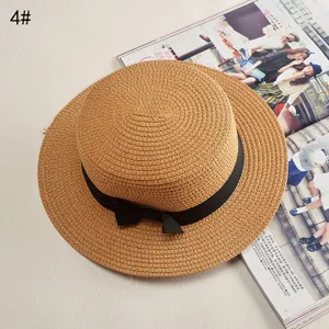 Stylish women's wide brim straw hat with black bow, perfect for summer sun protection.