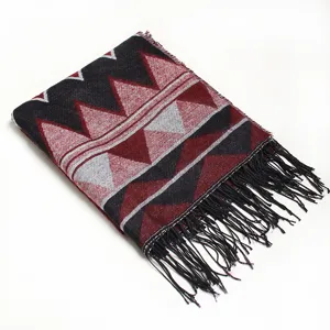 Detailed close-up of geometric pattern knitted fringe scarf shawl winter warm cozy apparel.