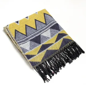 Detailed view of geometric pattern knitted shawl scarf with black tassels edge design.