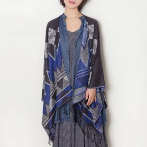 Detailed view of the stylish blue geometric patterned knit poncho shawl with fringes for women.