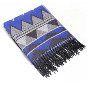 Detailed view of a cozy blue and grey geometric patterned fringe shawl scarf for women.