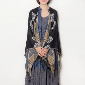 Geometric pattern tassel shawl cape detail shot, stylish autumn winter warm accessory wrap.