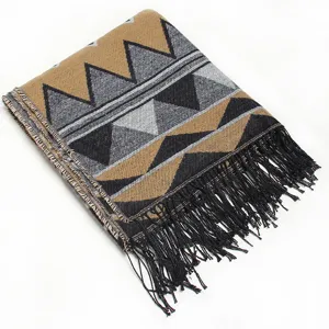 Detailed view of winter warm geometric patterned tassel shawl, soft knit folded fabric style.
