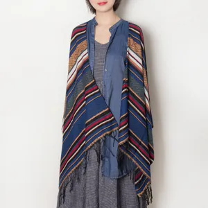 Detailed view of the geometric patterned fringe cape shawl showcasing the exquisite fabric texture.