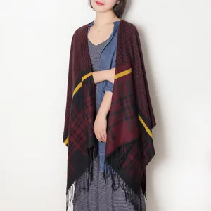 Detailed view of women autumn winter tassel cape shawl, cozy knitwear fringe design style.