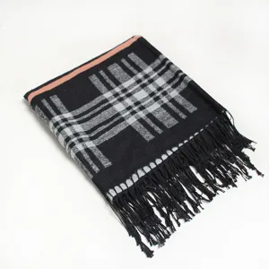 Detailed view of the black and grey plaid winter scarf with pink edge and fringe decor.