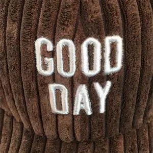Brown corduroy baseball cap detail shot featuring white embroidered GOOD DAY design.
