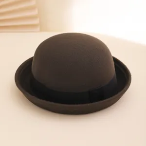 Close-up detail of the dark brown wool felt bowler hat featuring a classic black ribbon band.