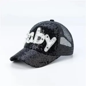 Close-up van zwarte pailletten pet met parel baby detail en ademend mesh achterkant.