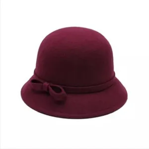 Detailed view of the elegant burgundy cloche hat featuring a cute side bow accent.