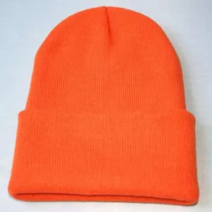 Détail en gros plan du bonnet en tricot orange vif, montrant une texture côtelée et un tissu doux.