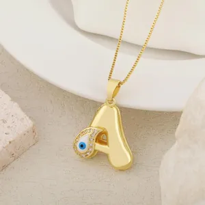 Gold plated letter A evil eye pendant necklace detail view, fashion DIY jewelry accessory.