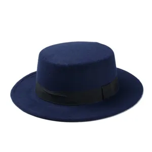 Classic navy blue flat top wool felt hat with black ribbon band, elegant vintage jazz cap.