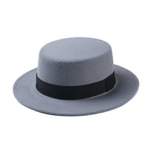Grey wool boater hat detail view showcasing flat top crown and elegant black ribbon band texture.