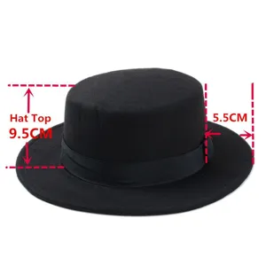 Classic black flat top wool fedora hat with ribbon band, vintage jazz hat detail shot.