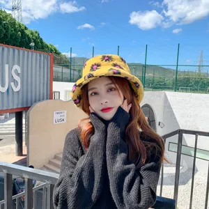 Plush fuzzy bucket hat for women, cute yellow winter warm hat with floral pattern detail.