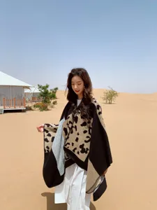 Detailed view of ethnic color-blocked leopard print poncho shawl, ideal for autumn winter outdoor.