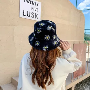 Detailed view of a cozy black fluffy bucket hat featuring cute white daisy floral patterns.