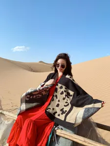 Detail view of ethnic color-block knit shawl cape, cozy autumn winter warm poncho outerwear.