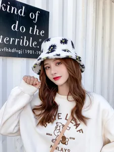 Cute fuzzy bucket hat for women winter warm white plush hat with black daisy pattern stylish.