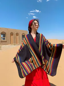 Details of the ethnic style colorful striped shawl cape, showcasing vibrant pattern and warm fabric.