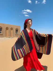 Ethnic colorful striped shawl cloak detail shot showing warm autumn winter outer wear design.