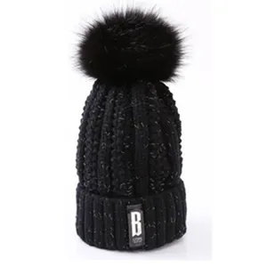 Black knit beanie hat with fluffy faux fur pom pom winter warm thermal cap for women