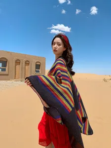 Ethnic colorful striped shawl detail, autumn winter warm cape cloak, cozy outdoor fashion wear.