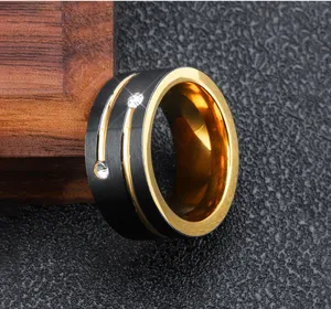 Detailed view of men's black and gold stainless steel ring with sparkling cubic zirconia stones.