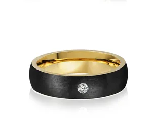 Detailed view of men's black brushed stainless steel ring with gold inner band and stone.