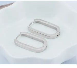 Detail view of minimalist stainless steel oval hoop earrings with sleek modern geometric design.