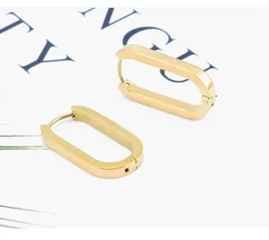 Detail shot of minimalist gold stainless steel geometric hoop earrings, sleek modern design.