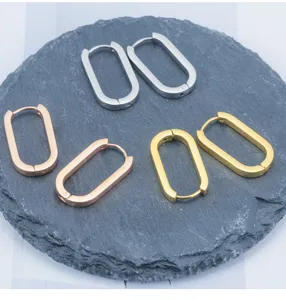 Detailed view of minimalist stainless steel oval hoop earrings in silver, gold, and rose gold.