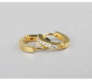 Close-up of minimalist gold stainless steel hoop earrings with sparkling crystal rhinestones.