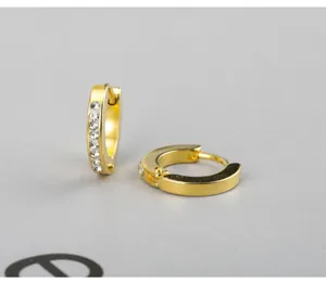 Close-up detail shot of gold-plated small hoop earrings with sparkling crystal rhinestones.