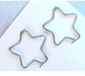 Exquisite stainless steel star hoop earrings with sparkling rhinestones, close-up view.