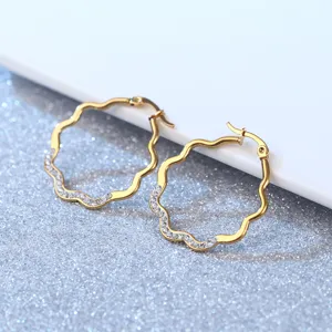 Chic gold-plated stainless steel wavy hoop earrings featuring sparkling micro-set crystal stones.