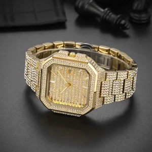 Luxury men's iced out square quartz watch with full rhinestones and metallic gold band.