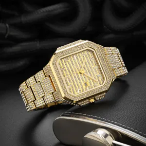 Close-up of a luxury men's iced out square quartz watch in gold with rhinestones.